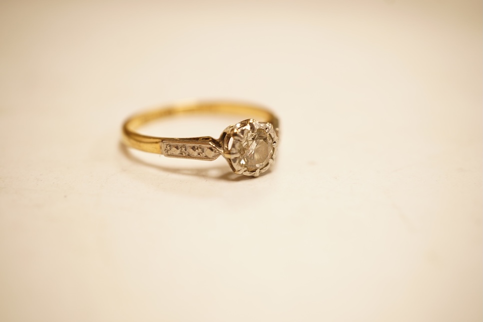 A modern yellow metal and single stone diamond set ring, with baguette and round cut diamond cluster set shoulders, total diamond weight approx. 0.50ct, size J/K (sizing spheres), gross weight 4.6 grams.